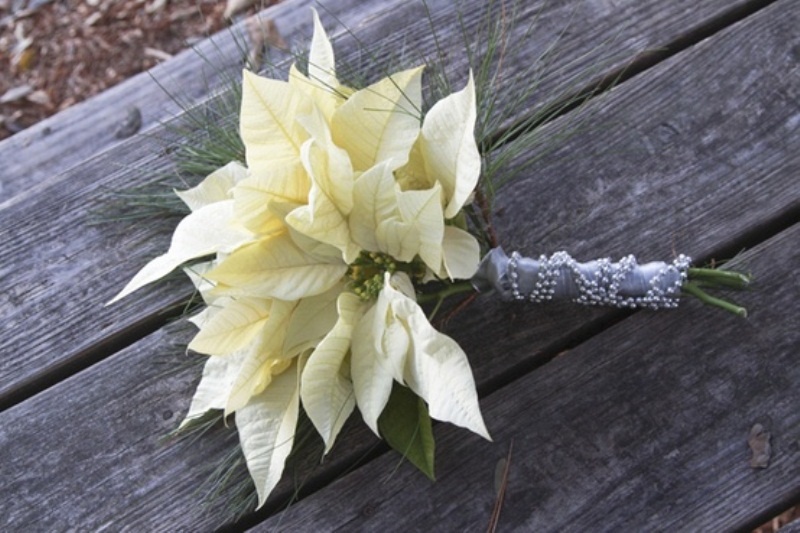 A white winter wedding bouquet with grasses is a cool winter option that is very easy to make