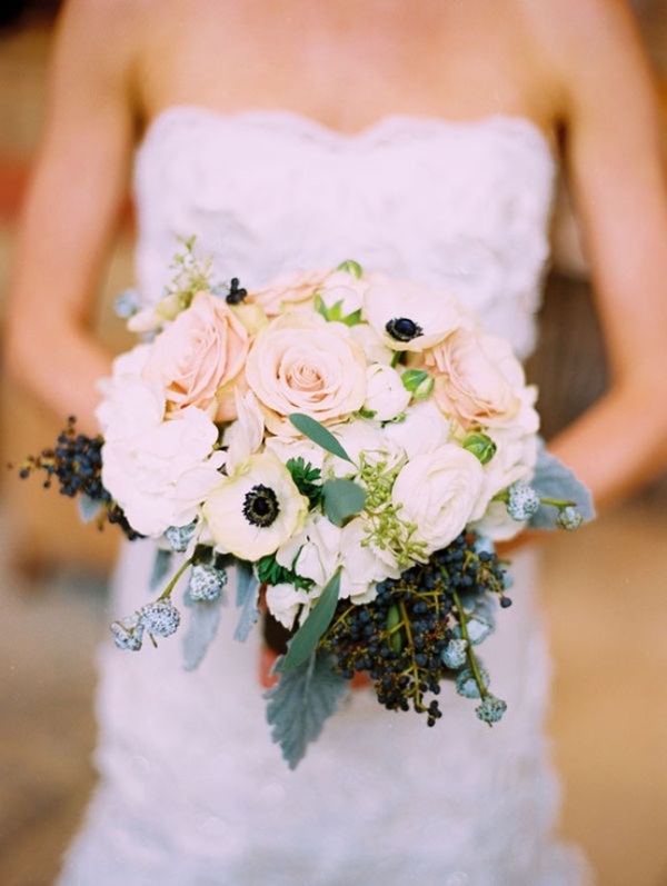 A neutral wedding bouquet of white and blush blooms, berries plus foliage is always a good idea
