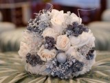 a neutral and silver winter wedding bouquet with blooms, pinecones and shiny beads to make it more glam