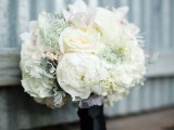 a white winter wedding bouqet with blooms, pale greenery is an ultimate choice for a winter wedding
