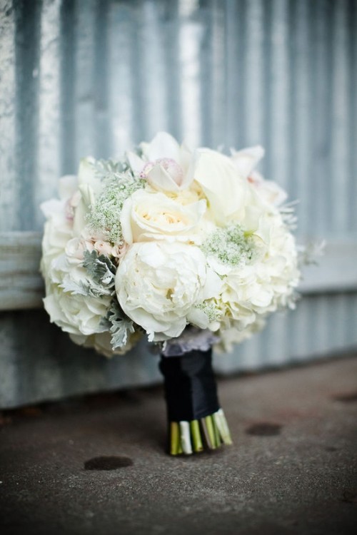 a white winter wedding bouqet with blooms, pale greenery is an ultimate choice for a winter wedding