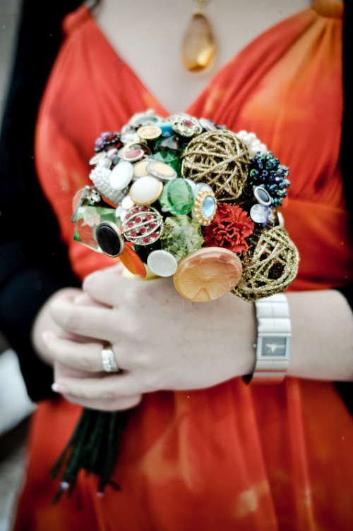 a non-typical wedding bouquet of buttons and brooches and glitter yarn balls is a very creative idea