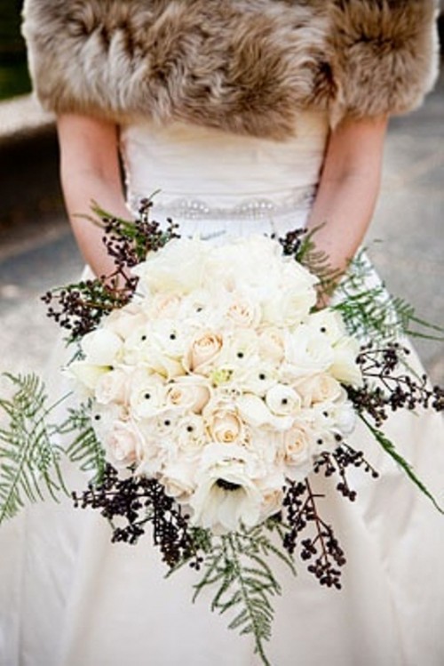 a winter wedding bouquet with lots of roses, berries and ferns is a luxurious and chic idea