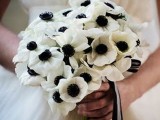 a white anemone wedding bouquet with black and white ribbons is a cool idea for a monochromatic wedding