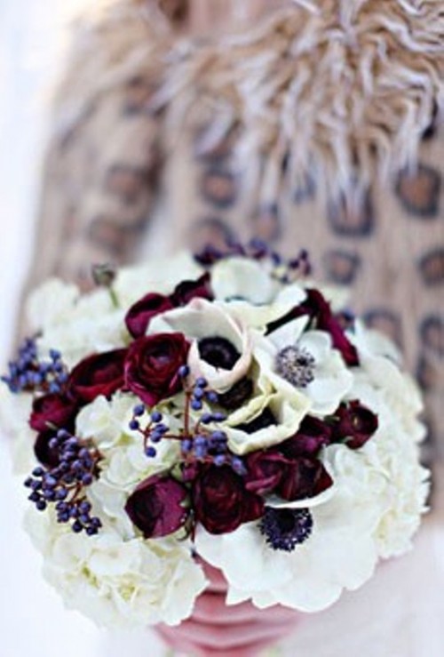 a bright winter wedding bouquet with white and deep red blooms plus berries will be a nice idea for winter