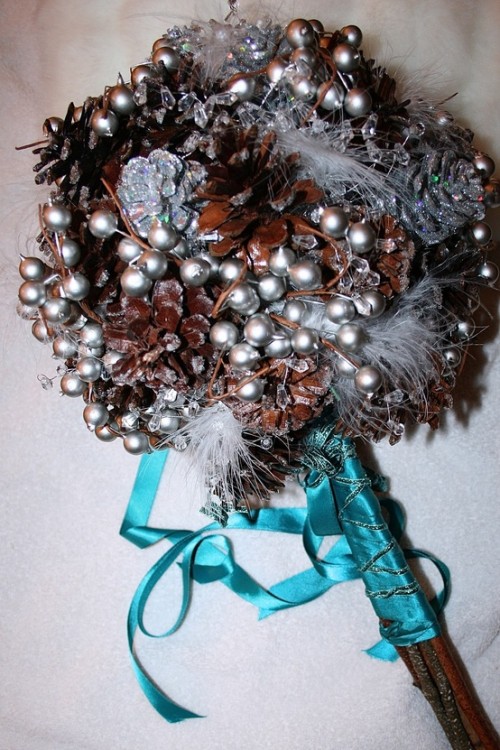a unique silver berry and pinecone wedding bouquet is very durable and very cool for winter