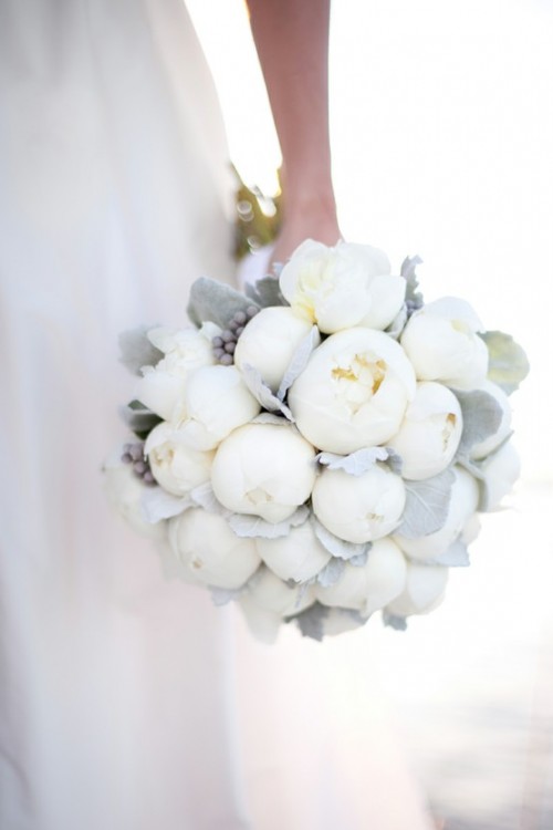 a chic white winter wedding bouquet with pale greenery with grey berries is a gorgeous idea