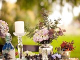 colorful blooms and foliage in vases, a urlap table runner and cutlery