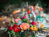 a lush and bright floral centerpiece with greenery and succulents plus mini apples looks boho and rustic