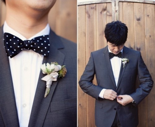 a grey suit and a black polka dot bow tie for a playful and elegant groom's outfit