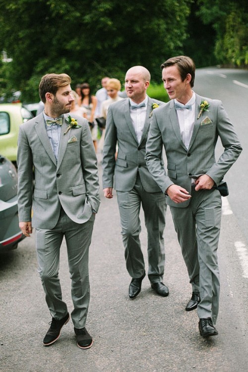 a grey suit, a grey shirt and a lemon yellow bow tie for a stylish summer groom's look