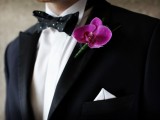 a black tux, a black and white polka dot bow tie and a pink orchid boutonniere for a luxurious and refined groom’s outfit