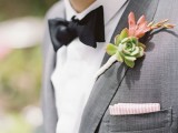 a grey suit, a white shirt, a black bow tie and a succulent boutonniere for an elegant spring or summer groom’s look