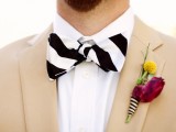 a tan suit, a striped bow tie, a colorful floral boutonniere for a bold and cool summer groom’s look