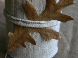 a candleholder covered with a cable knit cozie is a lovely decor idea for a winter or Christmas wedding