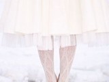 a tea-length wedding dress paired with white cable knit tights and nude shoes create a very cute vintage bridal look