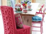 a chair covered with red cable knit is a cool idea for a winter or Christmas wedding, you will keep your guests cozier and warmer