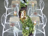 a sheer wedding table with a lush and long succulent wedding table runner of succulents of various shades