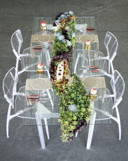 a sheer wedding table with a lush and long succulent wedding table runner of succulents of various shades
