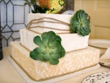 a square wedding cake with several tiers accented with a couple of succulents is a stylish modern idea