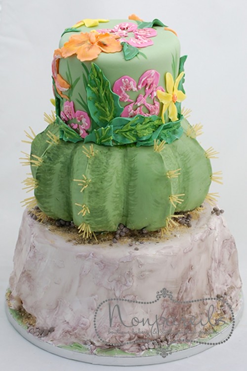 a fun colorful cactus wedding cake with a colorful tier with floral appliques is a gorgeous wedding dessert idea