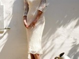 a fitting crochet midi wedding dress with long sleeves and a deep neckline, statement earrings and nude heels for a boho loving bride