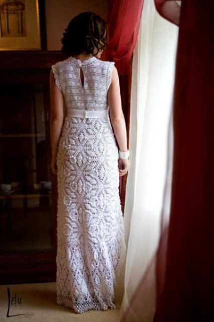 a crochet maxi wedding dress with a fitting silhouette, with cap sleeves and various patterns for a beach or boho bride
