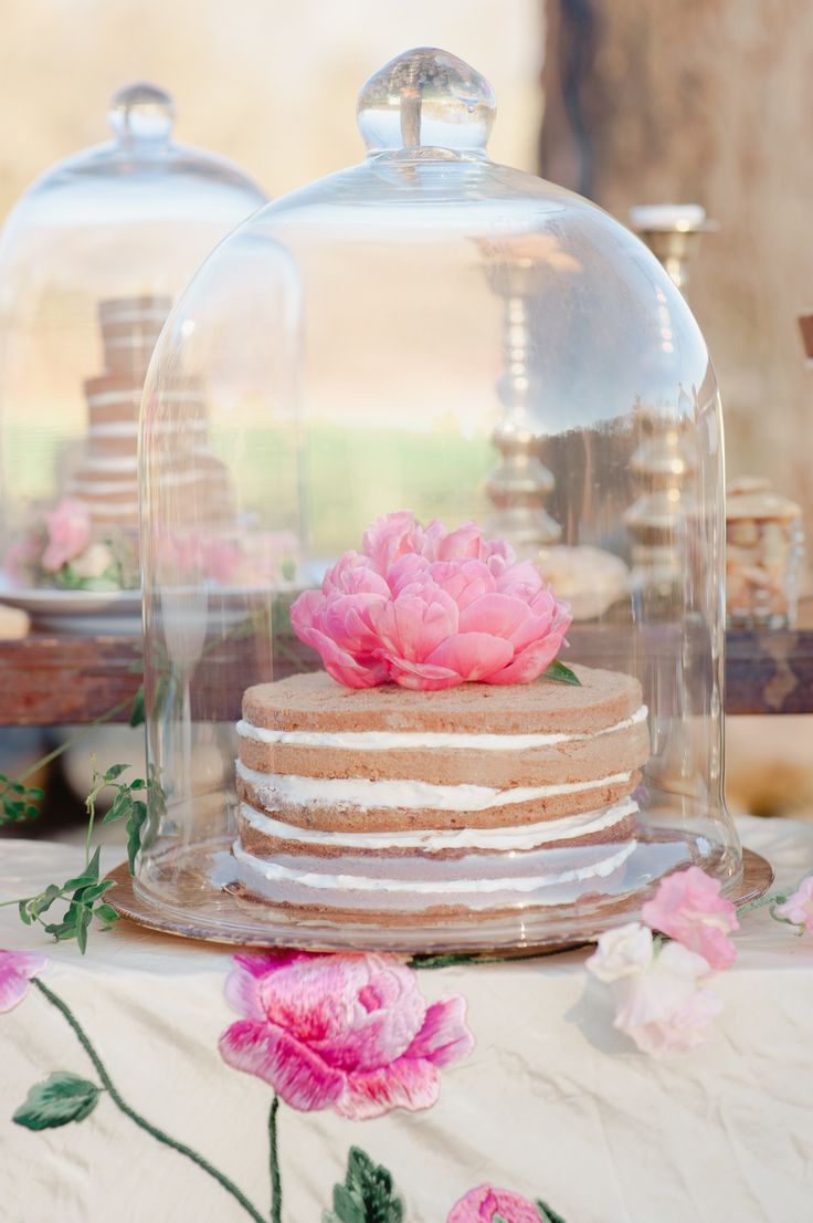 Naked cakes topped with fresh blooms can be saved from bugs in cloches that will match a garden bridal shower