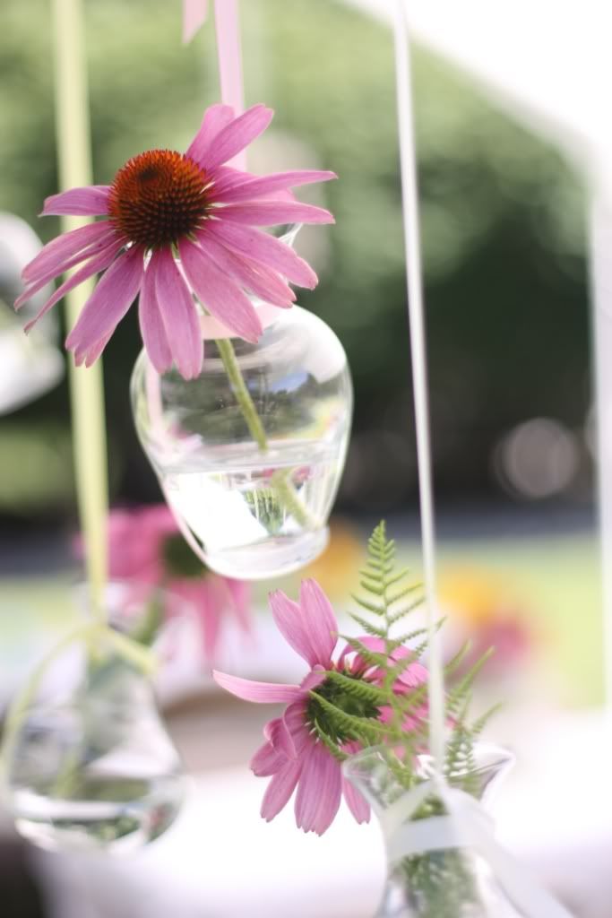 Fresh blooms and greenery in hanging vases and bottles will make your space feel very romantic and garden inspired
