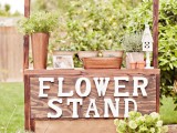a flower stand with blooms and greenery can be used for a garde bridal shower activity – making floral arrangements or bouquets