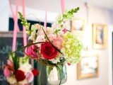 bright blooms in jars hanging on bright ribbon will be a lovely idea for having a garden bridal shower