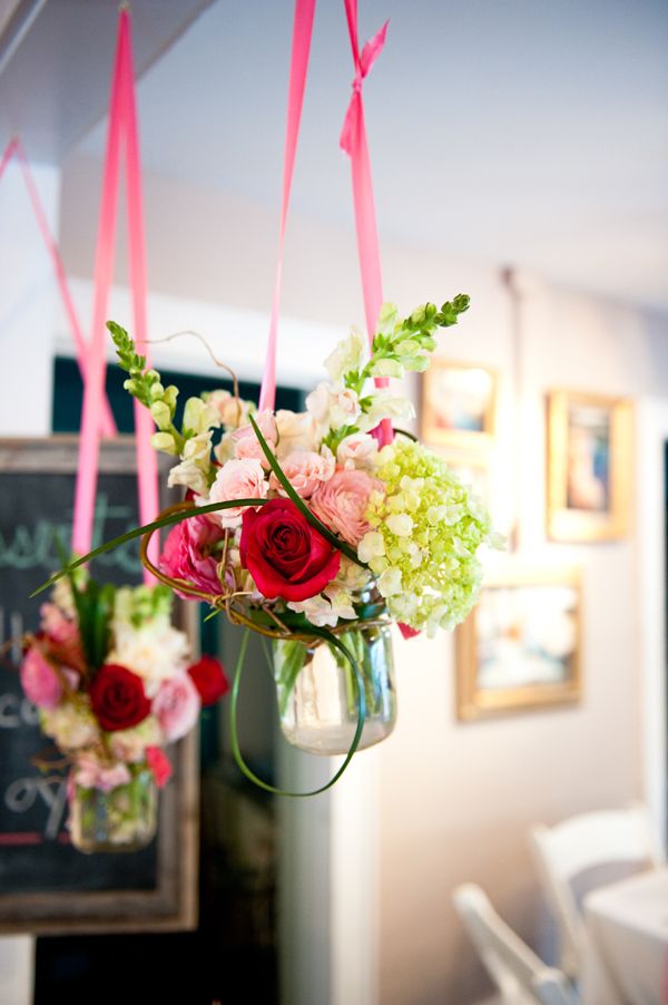 Bright blooms in jars hanging on bright ribbon will be a lovely idea for having a garden bridal shower