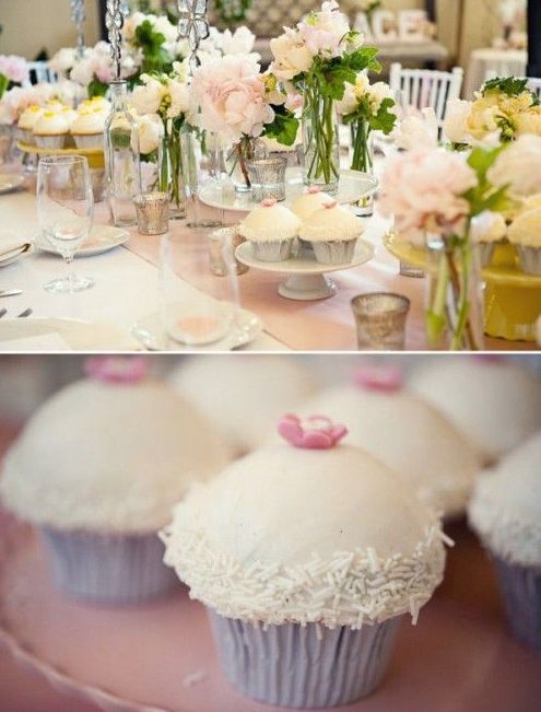 a beautiful pastel wedding tablescape with blush peonies and greenery, with a blush table runner and lots of sweets around