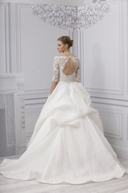 a refined wedding ballgown with a lace bodice, a high neckline, short sleeves, a layered skirt and a keyhole back is a bold idea