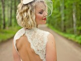 a lace fitting wedding dress with a high neckline, no sleeves, a keyhole back and a birdcage veil for a bold vintage-inspired look