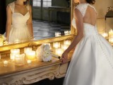 a refined wedding ballgown with a lace and beaded bodice and cap sleeves, a sweetheart neckline, a keyhole back on buttons and a sleek skirt with a train