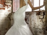 a sophisticated mermaid wedding dress with lace and beading, with no sleeves, a keyhole back, a high neckline and a train for a formal wedding