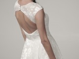 a modern enchanting A-line wedding dress with floral prints, a keyhole back on buttons, a high neckline and no sleeves