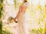 a lace mermaid wedding dress with a high neckline, cap sleeves, a keyhole back and a small train is timeless classics to rock