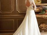 a dreamy A-line wedding dress with a lace bodice and long sleeves, with a keyhole back and a sleek skirt on buttons plus a train
