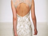 a modern romantic fitting wedding dress with lace appliques and beading, with no sleeves, a keyhole illusion back and a high neckline