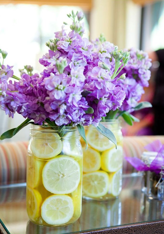 bright spring bridal shower centerpieces of purple blooms and lemon slices in jars
