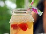 a jar with a lace cover, a bright straw and lemonade with berries is a great idea for a summer or spring vitnage bridal shower