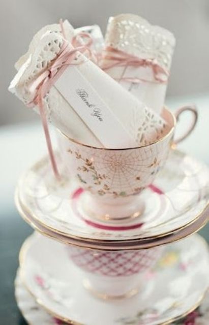 stacked vintage tecups holding wedding favors look super cute, they can be given as favors themselves