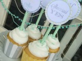 frosted cupcakes with striped liners and vintage cupcake toppers are amazing for a vintage bridal shower or wedding