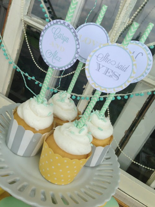 frosted cupcakes with striped liners and vintage cupcake toppers are amazing for a vintage bridal shower or wedding