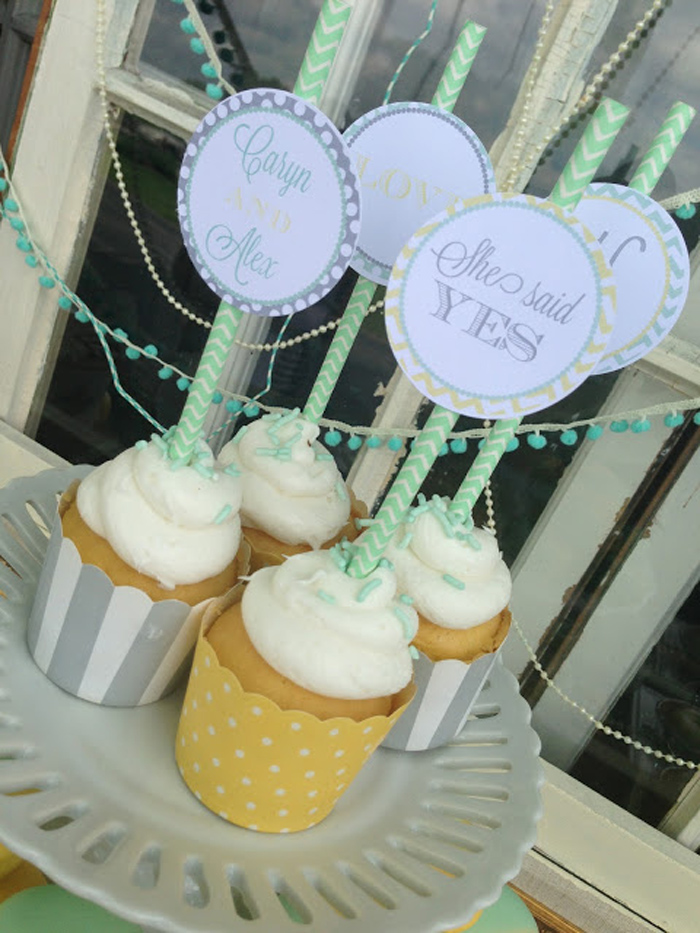 Frosted cupcakes with striped liners and vintage cupcake toppers are amazing for a vintage bridal shower or wedding
