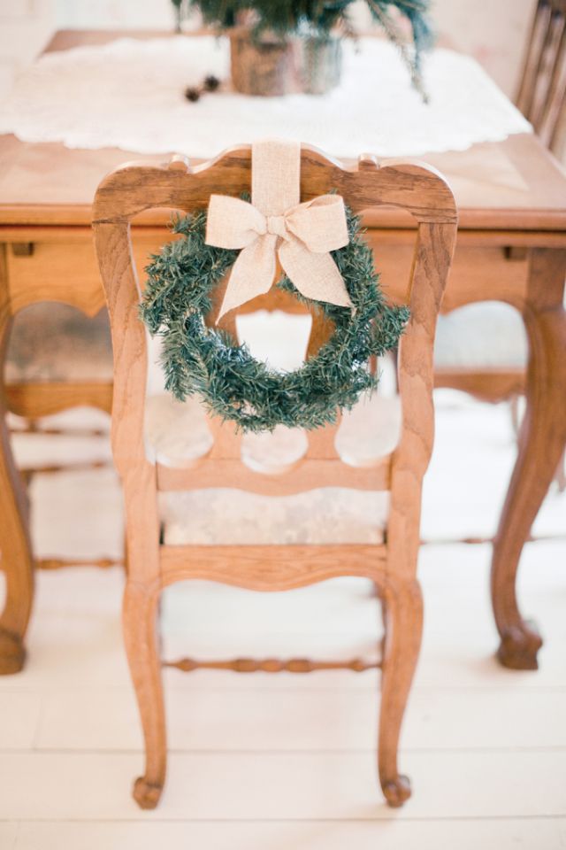 Accent the chairs with little evergreen wreaths with bows to give the venue a traditional Christmas feel
