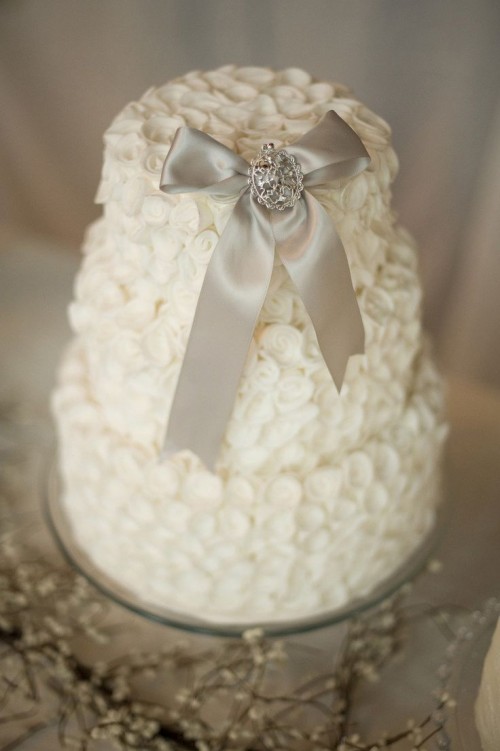 a winter bridal shower cake topped with an elegant sparkling bow is a chic idea with a classic feel