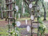 a woodland wedding arch of branches, with greenery, moss and lace embroidery hoops hanging down is a lovely idea with a natural feel